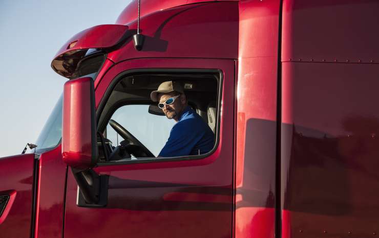 Usa,truck Driver, Man In A Red Lorry Cab.
