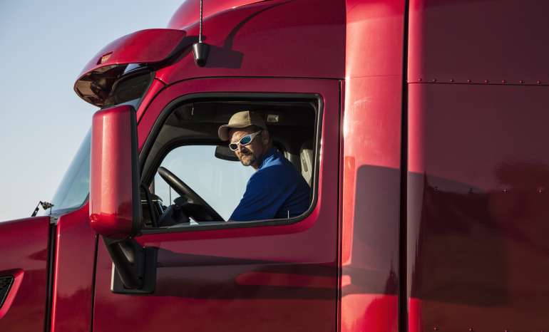 Usa,truck Driver, Man In A Red Lorry Cab.